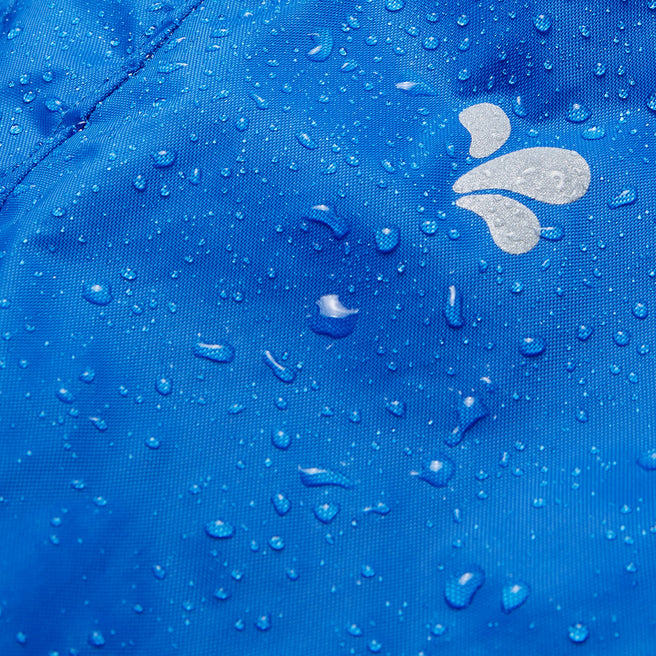 Close-up of Originals Waterproof Trousers Blue fabric, covered in water droplets, showing waterproof nature of the material and logo.